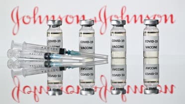 An illustration picture shows vials with Covid-19 Vaccine stickers attached and syringes with the logo of US pharmaceutical company Johnson & Johnson on November 17, 2020. (AFP)