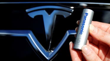 A Panasonic Corp’s lithium-ion battery, which is part of Tesla Motor Inc’s Model S and Model X battery packs, is pictured with the Tesla Motors logo at the Panasonic Center in Tokyo, Japan. (Reuters)