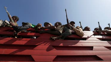 Members of Amhara region militias ride on their truck as they head to the mission to face the Tigray People's Liberation Front in Sanja