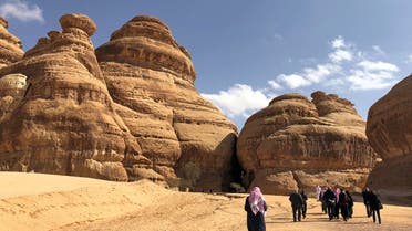 Visitors walk outside the tombs at the Madain Saleh antiquities site, al-Ula. (reuters)