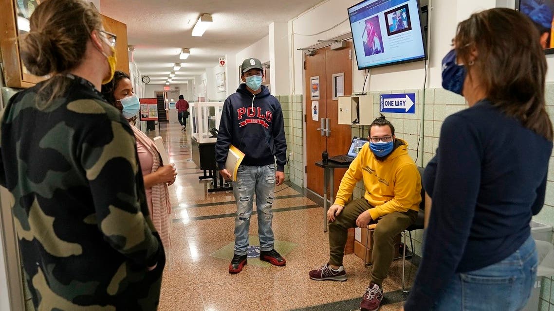 Teachers chat in the hallway at West Brooklyn Community High School after learning that the school would be closing for the third time this year due to the city's attempt to control the spread of coronavirus, Nov. 18, 2020. (AP)