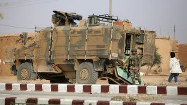 A Turkish soldier stands near his armoured vehicle on a highway near the northern Syrian town of Ain Issa in the countryside of the Raqqa region, on November 26, 2019, as Turkey-backed forces deploy reinforcements around the key town. Ankara and its Syrian proxies launched on October 9 a cross-border attack against Kurdish fighters in northern Syria, which allowed Turkey, along with a subsequent Russian-Turkish accord, to control a strip of land on the Syrian side of the border. Ain Issa lies on the southern edge of that strip of land, on the key M4 highway that runs east to west across the northern part of the war-torn country.