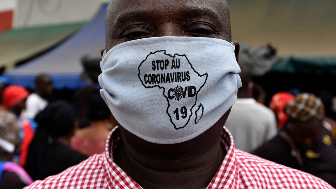 A man wears a stop coronavirus face mask with a map of Africa on it, April 24, 2020 in a street of Abobo, a district of Abidjan. (AFP)