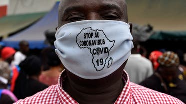 A man wears a stop coronavirus face mask with a map of Africa on it, April 24, 2020 in a street of Abobo, a district of Abidjan. (AFP)