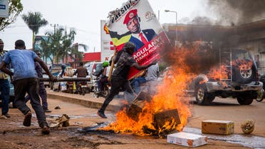 A supporter of Ugandan musician turned politician Robert Kyagulanyi, also known as Bobi Wine, carries his poster. (AFP)