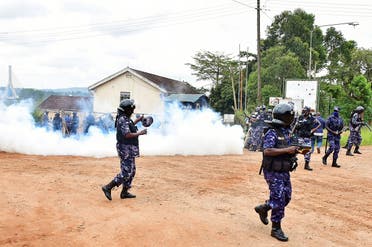 Ugandan riot policemen fire tear gas canisters to disperse supporters of presidential candidate Robert Kyagulanyi, also known as Bobi Wine, in Luuka district, eastern Uganda, on November 18, 2020. (Reuters)