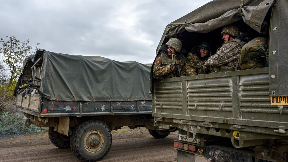Armenian soldiers leave Agdam in a truck on November 19, 2020 as the territory is due to be returned to Azerbaijan on November 20, 2020 as stipulated in a Moscow-brokered peace deal signed by Armenia and Azerbaijan on November 9. For three decades Azerbaijan's Aghdam district has been under the control of Armenian separatists, who have also governed the neighbouring region of Nagorno-Karabakh since a post-Soviet war in the 1990s.
