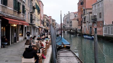 People sit at tables along the canal, as the number of people infected by the coronavirus disease (COVID-19) continues to rise, in Venice, Italy, November 14, 2020. (Reuters)