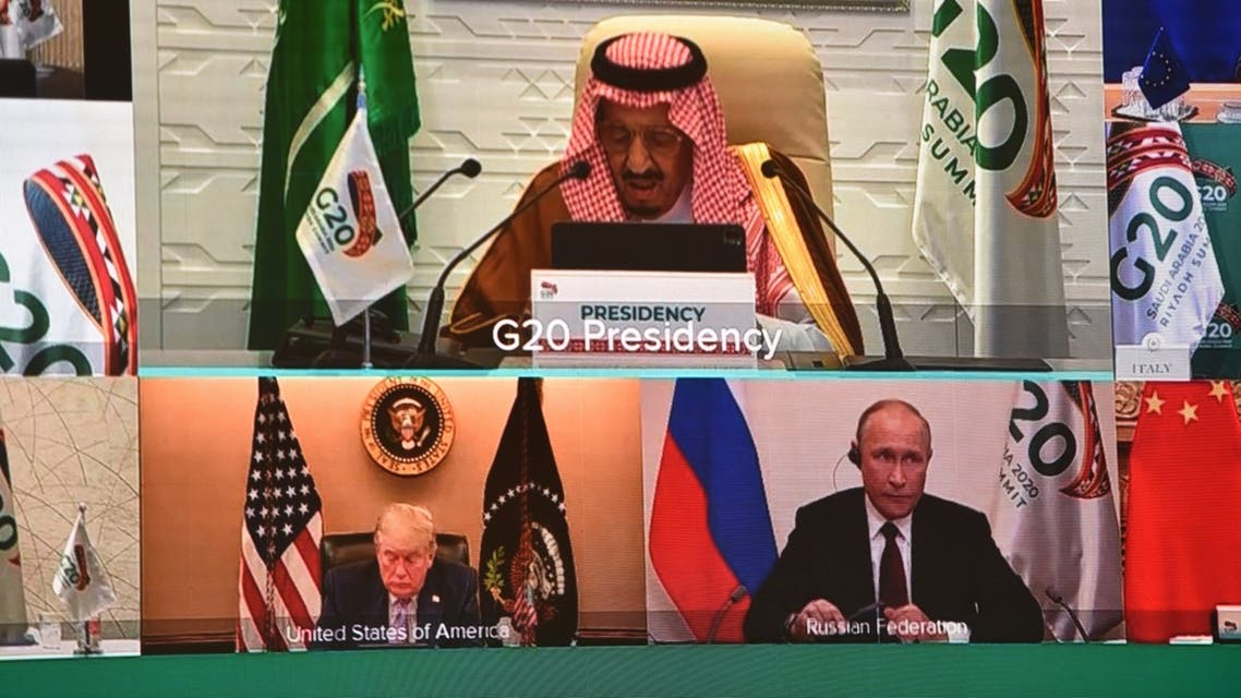 Japanese Prime Minister Yoshihide Suga (top L), US President Donald Trump (top R), Saudi Arabia's King Salman bin Abdulaziz Al Saud (C), South Korean President Moon Jae-in (3rd row, L), European Commission President Ursula von der Leyen (3rd row, R), and European Council President Charles Michel (down), are seen on a screen before the start of a virtual G20 summit hosted by Saudi Arabia and held over video conference amid the Covid-19 (novel coronavirus) pandemic, in Brussels, on November 21, 2020. Saudi Arabia hosts a G20 summit on November 21 and 22, in a first for an Arab nation, with the virtual forum dominated by efforts to tackle the coronavirus pandemic and the worst global recession in decades.