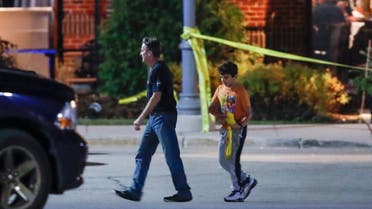 The mall shotting is the second such event in recent times. This file photo shows a man and a boy leave the Mayfair Mall in Wauwatosa, Wisconsin, on November 20, 2020, following a shooting. (AFP)