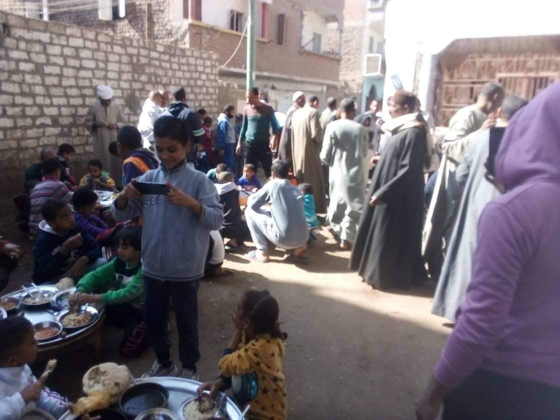 سكان النزلة يقدمون الطعام مجاناً امام مسجد القرية