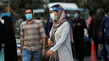 FILE PHOTO: An Iranian woman wears a mask and face shield, amid a rise in the coronavirus disease (COVID-19) infections, in Tehran, Iran October 24, 2020. Picture taken October 24, 2020. Majid Asgaripour/WANA (West Asia News Agency) via REUTERS ATTENTION EDITORS - THIS IMAGE HAS BEEN SUPPLIED BY A THIRD PARTY./File Photo
