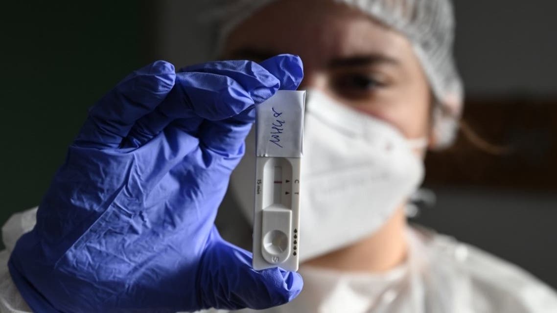 A member of the French Red Cross presents an antigen test at a mobile Covid-19 (novel coronavirus) screening, site on November 19, 2020, in Saint-Gilles, southeastern France. (AFP)