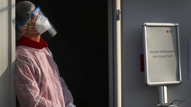 A member of Germany’s Red Cross medical staff waits for people at a newly installed drive- and walk-in corona test center in Frankfurt, Germany, November 13, 2020. (Reuters/Kai Pfaffenbach)