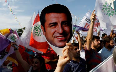 A supporter of Turkey’s main pro-Kurdish Peoples’ Democratic Party (HDP) holds a mask of their jailed former leader and presidential candidate Selahattin Demirtas during a rally in Ankara, Turkey, June 19, 2018. (Reuters/Umit Bektas)