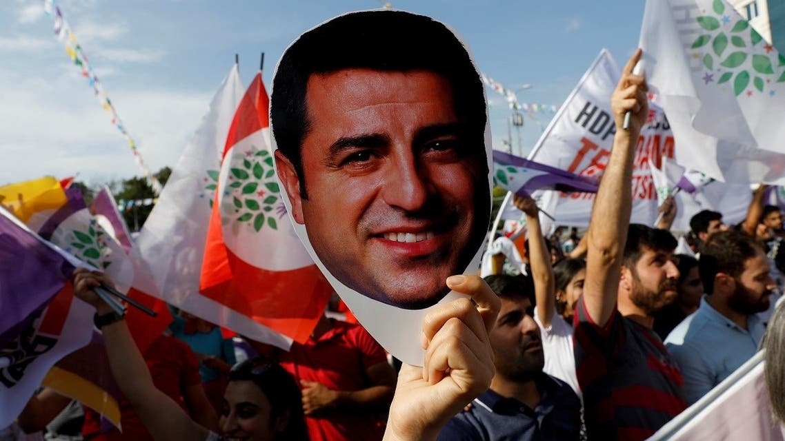 A supporter of Turkey’s main pro-Kurdish Peoples’ Democratic Party (HDP) holds a mask of their jailed former leader and presidential candidate Selahattin Demirtas during a rally in Ankara, Turkey, June 19, 2018. (Reuters/Umit Bektas)