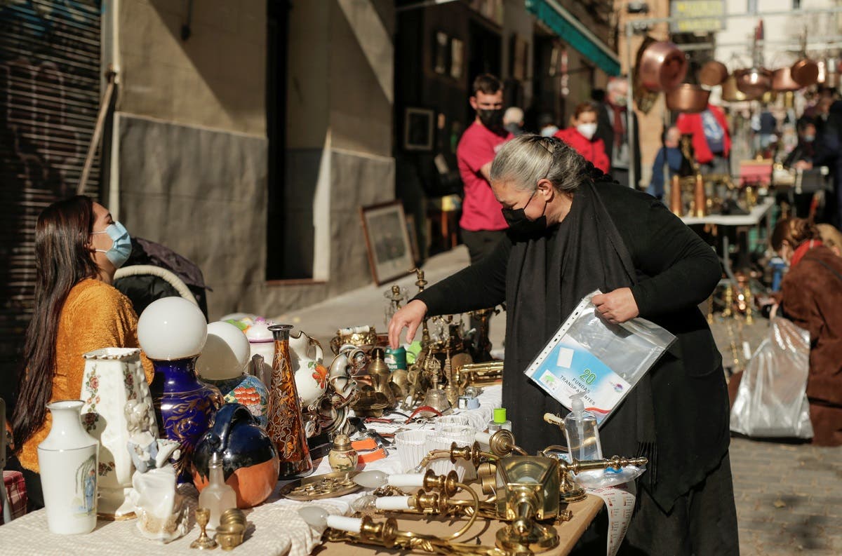 A woman shops at El Rastro flea market, amidst the coronavirus disease outbreak in Madrid, Spain November 22, 2020. (Reuters/Javier Barbancho)