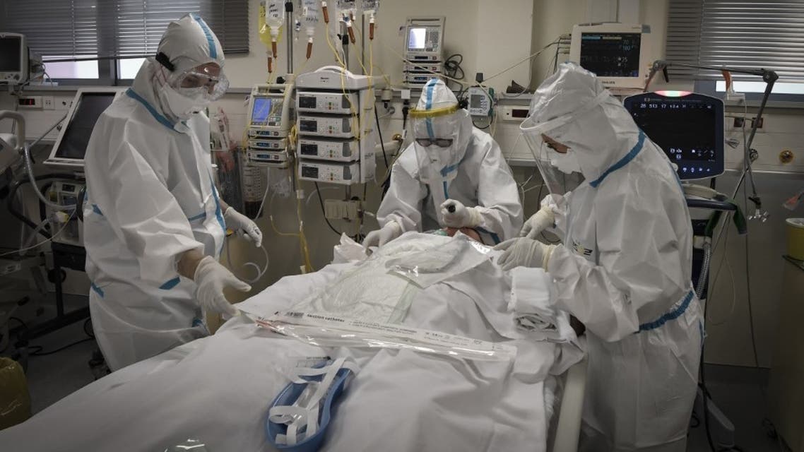 Nurses attend to a patient suffering form the novel coronavirus, Covid-19, in the Intensive Care Unit (ICU) at the Voula (Asklepeion) hospital located in an Athens' southern suburb on November 20, 2020. (AFP)