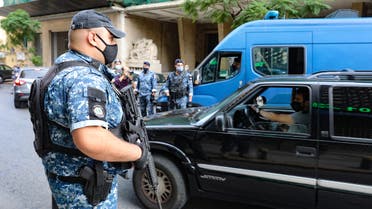Lebanese policemen control cars at a checkpoint in the Sanayeh district of the Lebanese capital Beirut a day after the country went into lockdown, in a bid to stem the spread of the novel coronavirus, on November 14, 2020. (AFP)