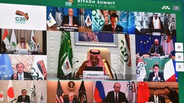 Displayed on a projected screen at the International Media Centre in Saudi Arabia's capital Riyadh on November 21, 2020, Saudi King Salman bin Abdulaziz gives an address opening the G20 summit, held virtually, while surrounding him are other G20-participating leaders. (AFP)
