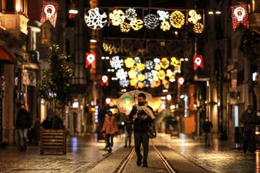 A few people walk in Istiklal street, the main shopping street in Istanbul, minutes into the lockdown, part of the new measures to try curb the spread of the coronavirus, Saturday, Nov. 21, 2020. (AP)