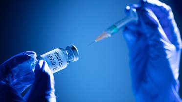 File photo taken on November 17, 2020 showing a syringe and a bottle reading Vaccine Covid-19. (AFP)