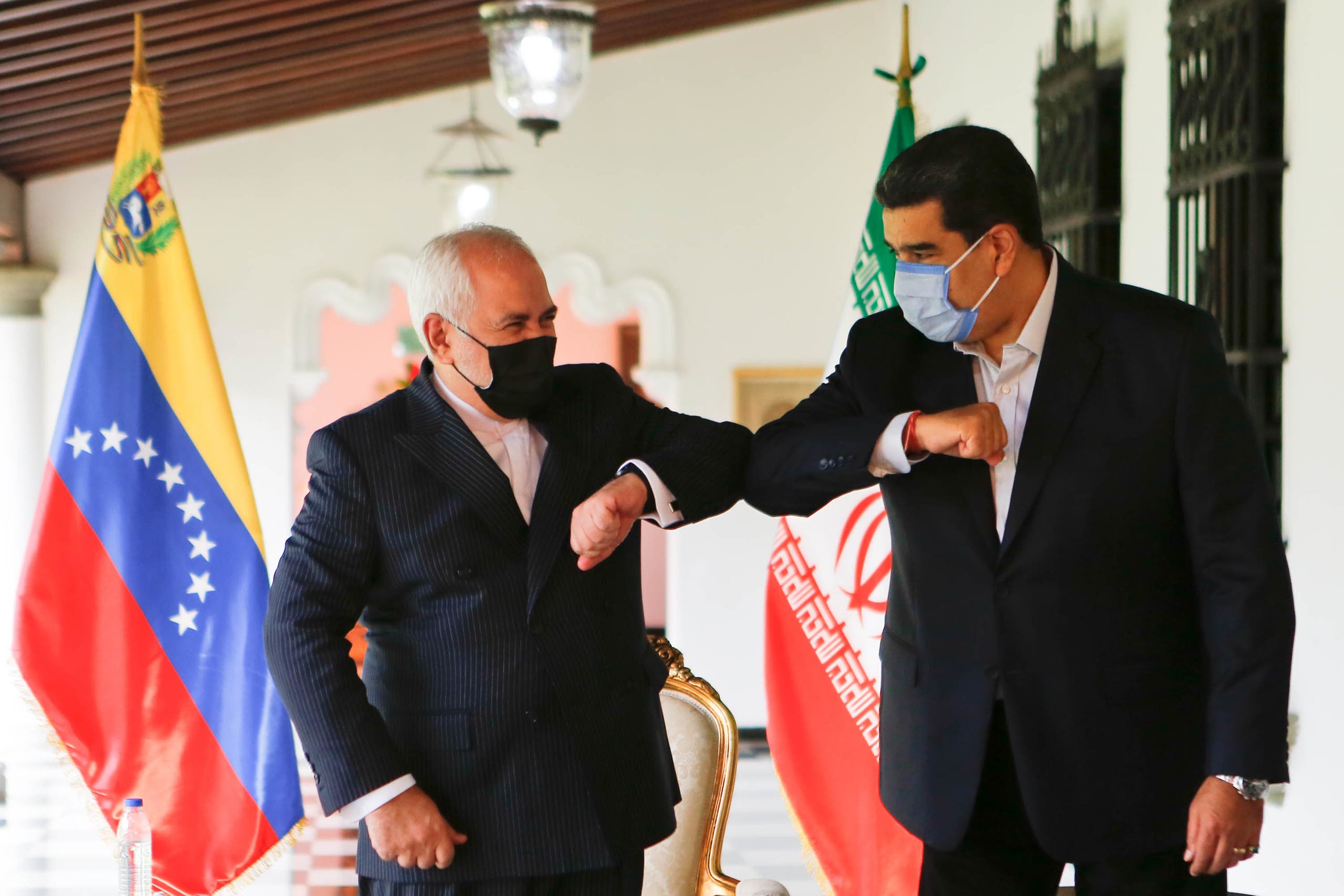 Venezuela's President Nicolas Maduro (R) bumping elbows with the Foreign Minister of the Islamic Republic of Iran, Javad Zarif (L) at Miraflores Palace in Caracas, on November 5, 2020. (File photo: AFP)