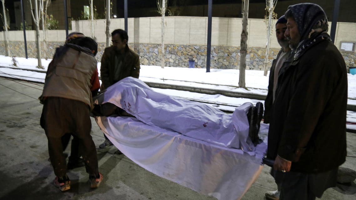 Volunteers carry to a hospital the body of a victim after two blasts ripped through in the city of Bamiyan on November 24, 2020. At least 14 people were killed in central Afghanistan on November 24 when two blasts ripped through the historic city of Bamiyan, home to many members of the mainly Shiite Hazara ethnic minority, officials said.