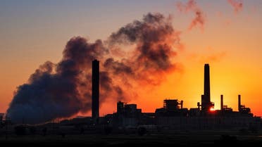 The Dave Johnson coal-fired power plant is silhouetted against the morning sun in Glenrock, Wyoming, July 27, 2018. (AP)