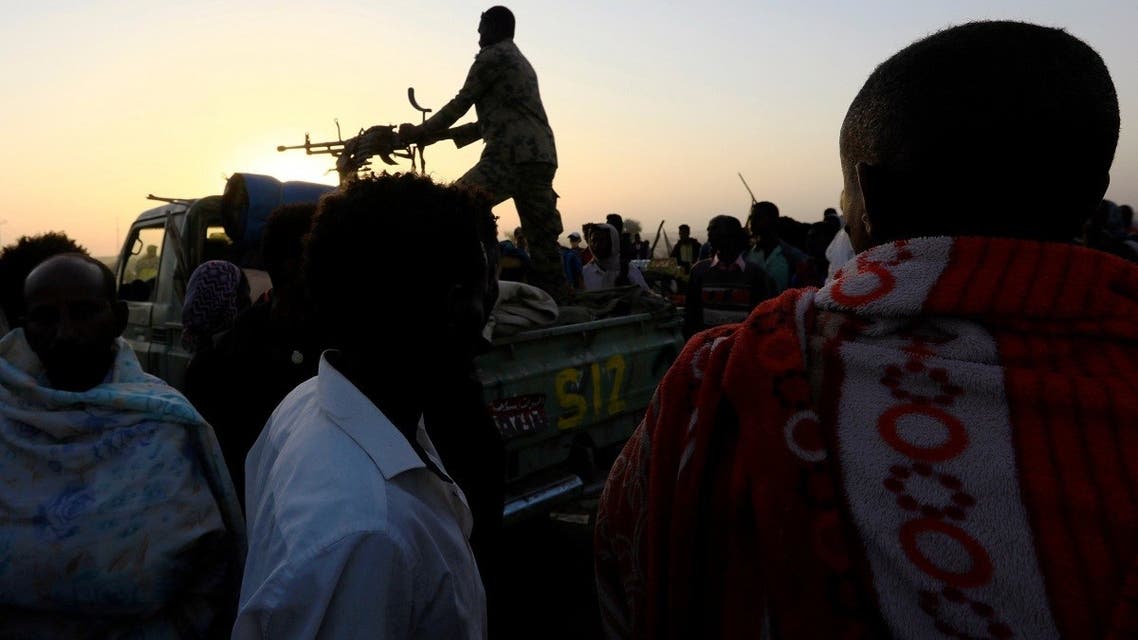 A Sudanese military officer patrols as Ethiopians who fled the ongoing fighting in Tigray region, gather Hamdayet village near the Setit river on the Sudan-Ethiopia border in eastern Kassala state, Sudan, on November 22, 2020. (Reuters)