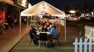 People dine in a tent temporarily set up in the parking lot of a restaurant in La Habra, California, Nov. 17, 2020. (AP)