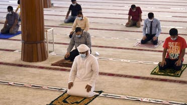 Worshippers keeping a safe distance from one another perform prayers at a mosque in UAE after reopening places of worship following months of closure to avoid the spread of the Covid-19. (AFP)