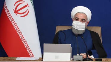 A handout picture provided by the Iranian presidency shows President Hassan Rouhani wearing a protective mask due to the COVID-19 coronavirus pandemic while chairing a cabinet meeting in the capital Tehran on November 11, 2020. (AFP)