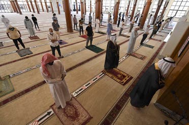 Worshippers keeping a safe distance from one another perform prayers at a mosque in the emirate of Sharjah in the United Arab Emirate.