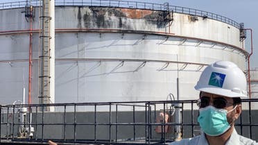 An employee at the Saudi Aramco oil facility gestures while standing near a damaged silo, at the plant in Saudi Arabia's Red Sea city of Jeddah on November 24, 2020. (AFP)