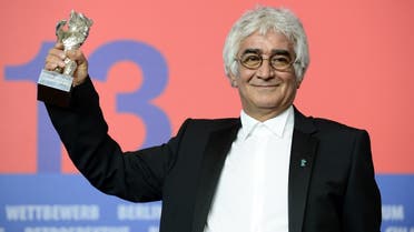 In this file photo taken on February 16, 2013, Iranian director Kambuzia Partovi holds his Silver Bear for Best Script award he received in place of Jafar Panahi (not pictured) for the movie “Parde” (Closed Curtain) during a press conference following the 63rd Berlinale awards ceremony in Berlin. (John MacDougall/AFP)