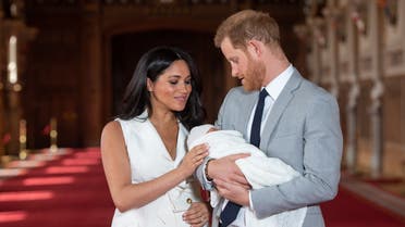 (FILES) In this file photo taken on May 08, 2019 Britain's Prince Harry, Duke of Sussex (R), and his wife Meghan, Duchess of Sussex, pose for a photo with their newborn baby son, Archie Harrison Mountbatten-Windsor, in St George's Hall at Windsor Castle in Windsor, west of London on May 8, 2019. Meghan Markle has revealed she suffered a miscarriage in July this year, writing in the New York Times on November 25, 2020 of the deep grief and loss she endured with her husband Prince Harry.