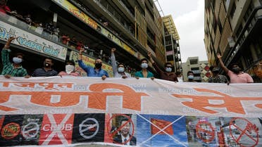 Activists display a banner and shout slogans during a protest against China outside a mobile phone market in Ahmedabad, India. (File photo: AP)