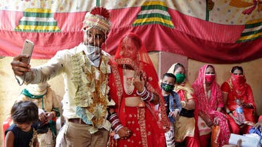 Couple Sachin Chandaliya and SonIya Bohat take a selfie after getting married at a marriage bureau at Bandra in Mumbai, India, Monday, June 15, 2020. (AP)