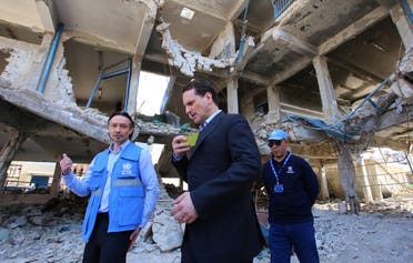 Pierre Krahenbuhl (C), Commissioner-General for the for the United Nations Relief and Works Agency for Palestine Refugees in the Near East (UNRWA) visits a damaged UNRWA school in Sit-Zeinab, a southern suburb of the Syrian capital, Damascus, on March 10, 2015. (AFP/Youssef Karwashan)
