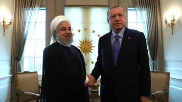 Turkish President Recep Tayyip Erdogan (R) and Iranian President Hassan Rouhani (L) shake hands before their meeting at the Presidential Palace in Ankara on September 16, 2019. (AFP)