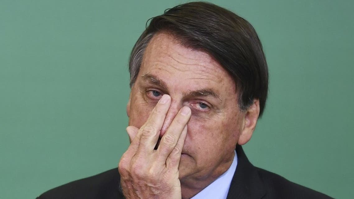 Brazilian President Jair Bolsonaro gestures during the commemoration of the 54th anniversary of the creation of Brazil's Tourism Board at Planalto Palace in Brasilia, on November 17, 2020. (AFP)