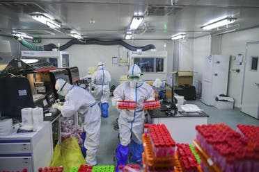 This photo taken on November 23, 2020 shows technicians processing COVID-19 coronavirus tests at a laboratory in Tianjin, China. (AFP)