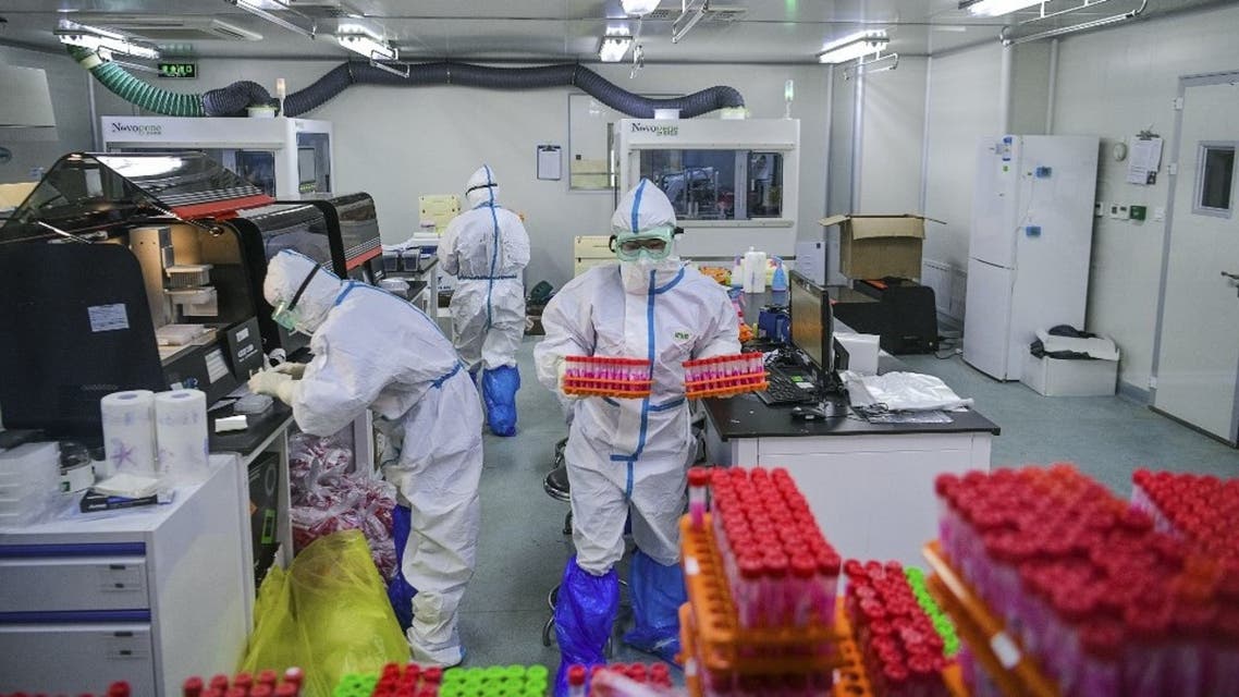 This photo taken on November 23, 2020 shows technicians processing Covid-19 coronavirus tests at a laboratory in Tianjin, China. (AFP)