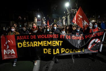 People hold a banner reading “enough violence and police crimes, disarm the police” as they take part in a demonstration, on November 26, 2020, in Toulouse, southern France. (Lionel Bonaventure/AFP)