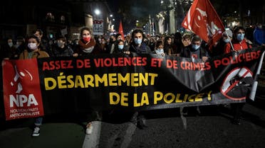 People hold a banner reading “enough violence and police crimes, disarm the police” as they take part in a demonstration, on November 26, 2020, in Toulouse, southern France. (Lionel Bonaventure/AFP)