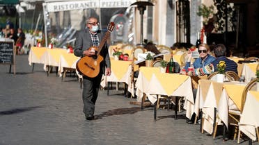 A musician walks in Piazza Navona square, as the spread of the coronavirus disease (COVID-19) continues, in Rome, Italy November 23, 2020. (Reuters/Yara Nardi)
