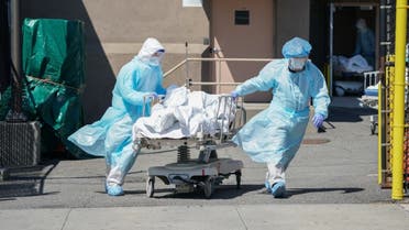 Bodies of coronavirus victims are moved to a refrigeration truck serving as a temporary morgue at Wyckoff Hospital in the Borough of Brooklyn on April 6, 2020 in New York. (AFP)