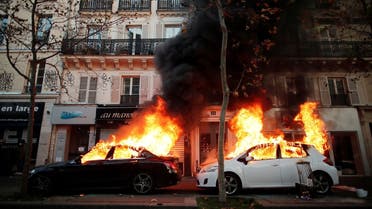 Cars burn during a demonstration against the “Global Security Bill” in Paris, November 28, 2020. (Reuters/Benoit Tessier)