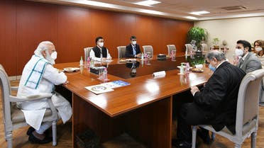 India’s PM Narendra Modi (L) chairing a meeting during his visit to the Serum Institute of India to review the coronavirus vaccine development, in Pune, November 28, 2020. (Indian Press Information Bureau PIB/AFP)